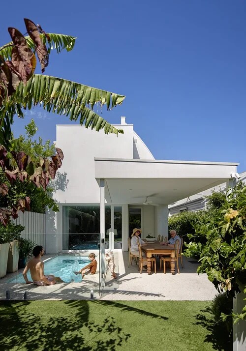Back of the house with a covered outdoor dining area beside the plunge pool